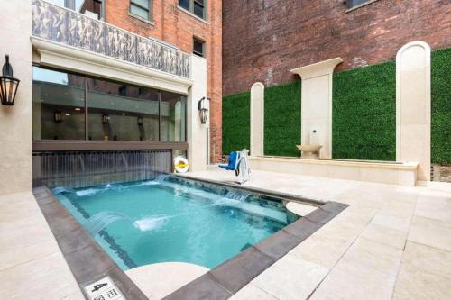 a swimming pool in the courtyard of a building at Curtiss Hotel, an Ascend Collection Hotel in Buffalo