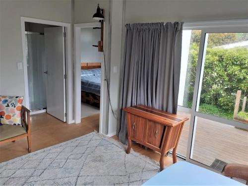a room with a bedroom with a bed and a window at Peace and quiet in the Brooklyn hills in Wellington
