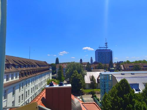 an aerial view of a city with a tall building at WHLIVING - Apartments & Studios in Konstanz in Konstanz