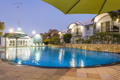 a large swimming pool in front of some buildings at Mandurah Quay Resort in Mandurah