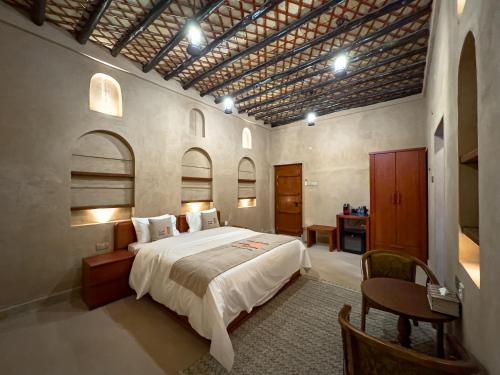 a bedroom with a large bed in a room at IHYAA Inn - نزل إحياء in Nizwa