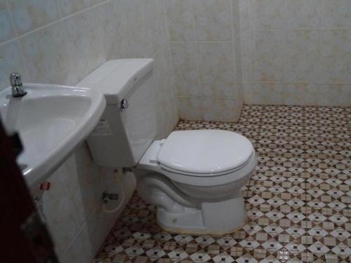 a bathroom with a white toilet and a sink at Phetphaylin Hotel in Pakse