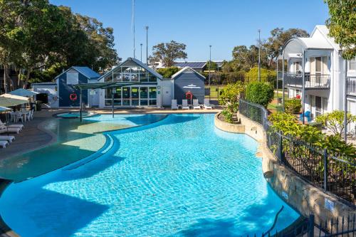 a large swimming pool in front of a building at Mandurah Quay Resort in Mandurah
