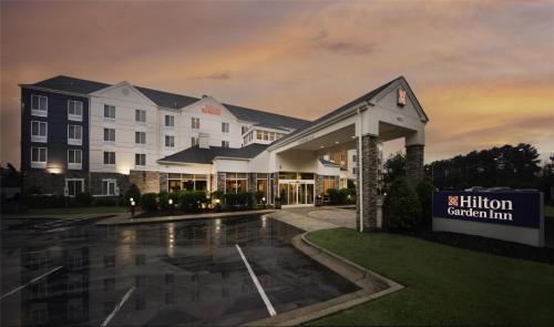 a hotel building with a sign in front of it at Hilton Garden Inn Fayetteville/Fort Bragg in Fayetteville