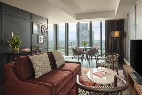 a living room with a couch and a table at The Gantry London, Curio Collection By Hilton in London