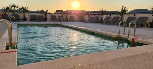 a swimming pool on the roof of a building at Ibis Styles Madrid Airport Valdebebas in Madrid