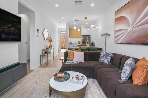 a living room with a couch and a table at Quiet Suburban Escape Near Shops & Dining in Gepps Cross