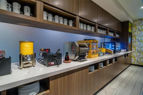 a kitchen with a counter with a appliance on it at Home2 Suites By Hilton Bolingbrook Chicago in Bolingbrook