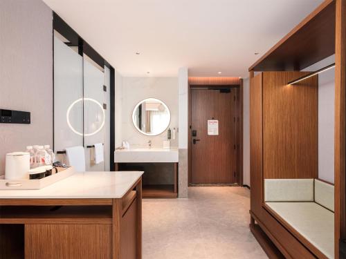 a bathroom with a sink and a mirror at Hilton Garden Inn Taiyuan Jiefang Road in Taiyuan
