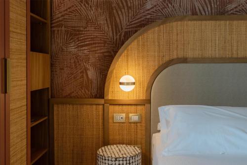 a bedroom with a bed and a lamp and a bed at Terradamari Resort & Spa Marina di Modica,Tapestry by Hilton in Marina di Modica
