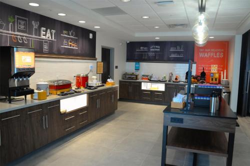 a large kitchen with wooden cabinets and a counter at Hampton Inn Cabot in Cabot