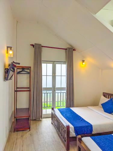 a bedroom with a bed and a ladder and a window at Ivy Home in Nuwara Eliya