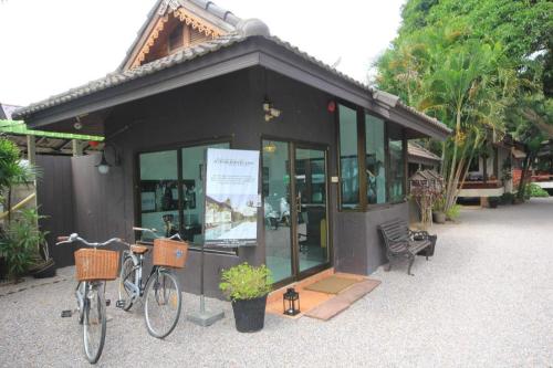 a building with two bikes parked outside of it at Seascape Resort Baan Krood in Ban Krut