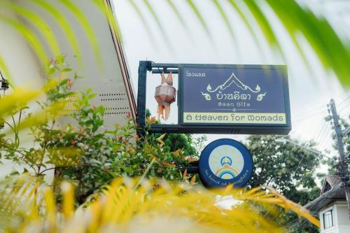 a sign for a resort with a sign for a basketball at Gita's House in Chiang Rai