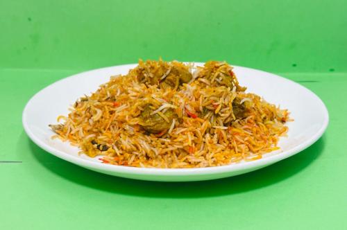 a plate of rice on a green table at Hotel BnB Mhepi in Kathmandu