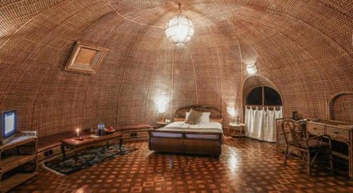 a large room with a bed and a table in it at Grand Norling Hotel's Resort in Kathmandu