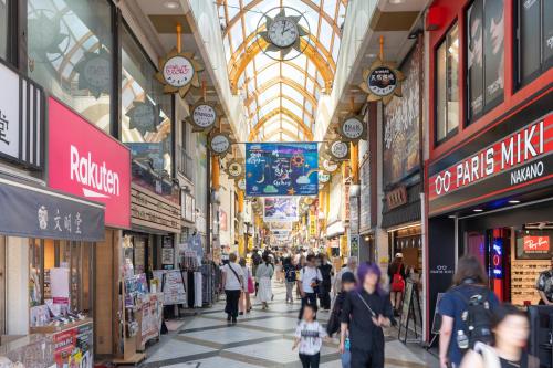 a shopping mall with people walking through it at PREAS Nakano Arai in Tokyo