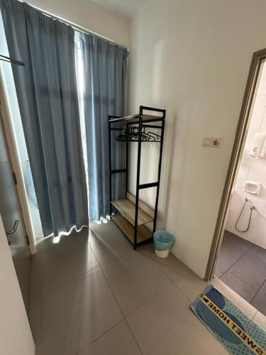 a room with a bathroom with a shower and a window at AYAAN PENTHOUSE at Golden Hill Night Market View in Brinchang