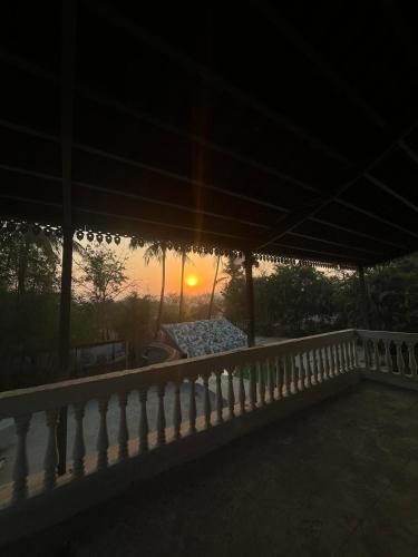 a sunset from the balcony of a house at Riveredgemanor in Pālghar