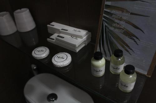 a bathroom with a sink and toiletries on a counter at VillaTel Salse in Bandung