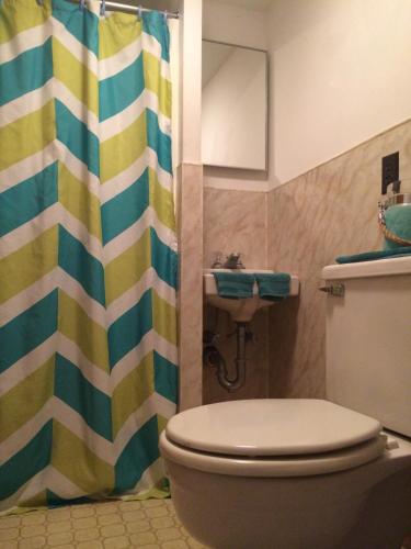 a bathroom with a toilet and a sink at Surfside Inn Chatham in Chatham