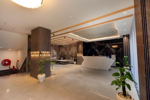 a lobby with potted plants in a building at VERTTU Horizon Delhi Airport Free Airport Pick Up in New Delhi