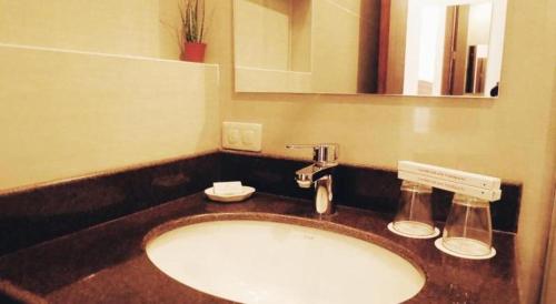 a bathroom with a sink and a mirror at Country Chateau Hotel in Kaybagal