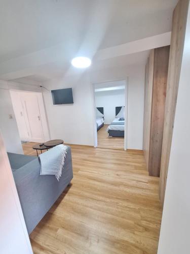 a room with two beds and a television in it at Helmstedt City Apartment in Helmstedt