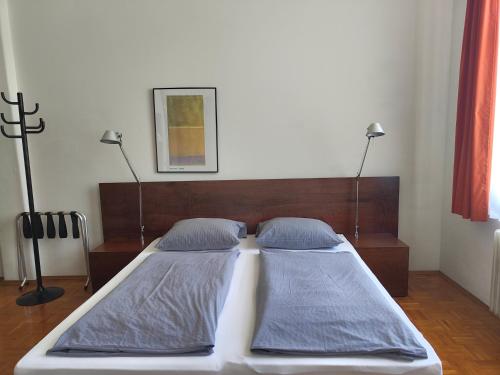 a bedroom with a bed with two pillows at WHLIVING - Apartments & Studios in Konstanz in Konstanz