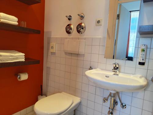 a bathroom with a sink and a toilet at WHLIVING - Apartments & Studios in Konstanz in Konstanz