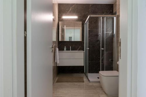 a bathroom with a shower and a toilet and a sink at AURA Apt Modern 1BR in Central Limassol and Free Parking in Limassol