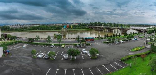 a parking lot next to a river with a bridge at Huangshan International Hotel in Huangshan