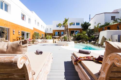 a patio with chairs and a swimming pool at Vista Roses Mar - Villas Batik in Roses