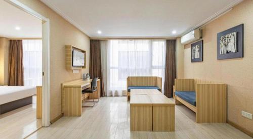 a hospital room with a bed and a desk at City Comfort Inn Wuhan Hankou Railway Station West Square in Wuhan