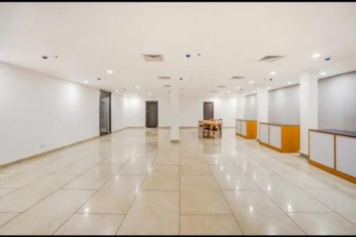 a large white room with a table in the middle at RROOMS Hotel La-Maison in Lucknow