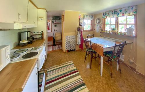 a small kitchen with a table and a kitchen with a stove at 2 Bedroom Stunning Home In Kalmar in Kalmar