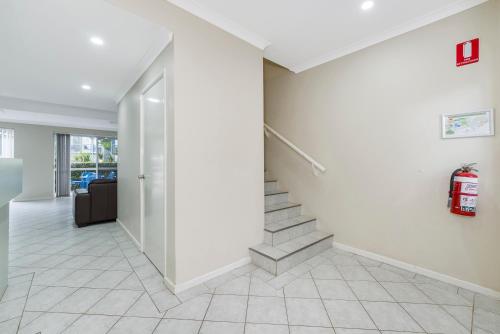 an empty hallway with stairs in a house at Mandurah Quay Resort in Mandurah