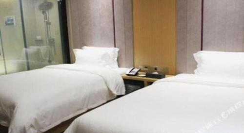 a hotel room with two beds and a shower at Lavande Hotels·Qingyuan Jinbiwan in Qingyuan
