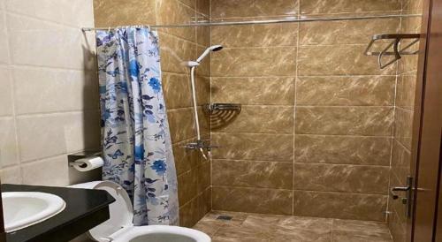 a bathroom with a shower and a toilet and a sink at ICON Hotel in Phnom Penh