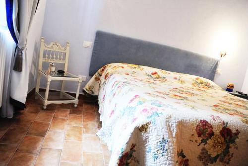 a bedroom with a bed and a side table at Casale Del Colle | Perugia in Collestrada