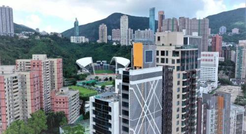 a view of a city with many tall buildings at Elysion Place Hotel Causeway Bay in Hong Kong