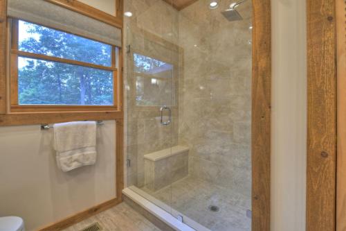 a bathroom with a shower with a glass door at Honey Hill Gorgeous long-range mountain views in Morganton