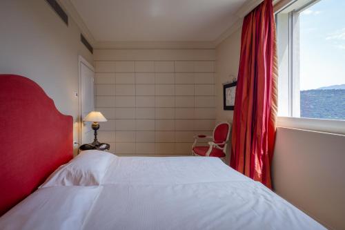 Ein Bett oder Betten in einem Zimmer der Unterkunft Resort Collina d'Oro - Hotel, Residence & Spa