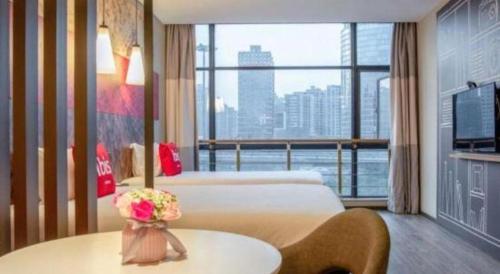 a hotel room with a bed and a large window at ibis xian North Second Ring Weiyang Rd Hotel in Xi'an