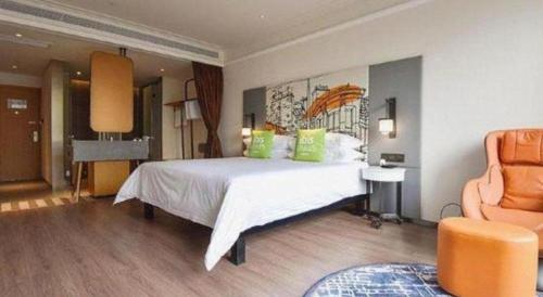 a bedroom with a large white bed with green pillows at ibis xian North Second Ring Weiyang Rd Hotel in Xi'an