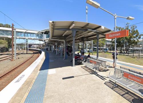 a train station with people waiting for the train at Entire Home in Blacktown in Blacktown