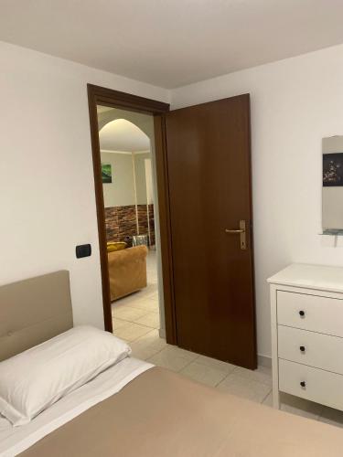 a bedroom with a bed and a wooden door at Bellagio Little Apartment in Bellagio