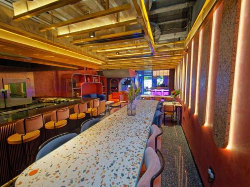 a dining room with a long table and chairs at Hotel Soloha @ Chinatown in Singapore