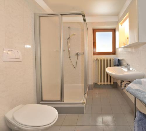 a bathroom with a shower and a toilet and a sink at Residence Hofer in Bressanone