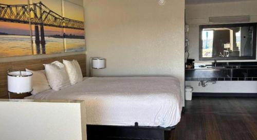 a hotel room with a bed and a sink at Days Inn & Suites by Wyndham Byram in Byram